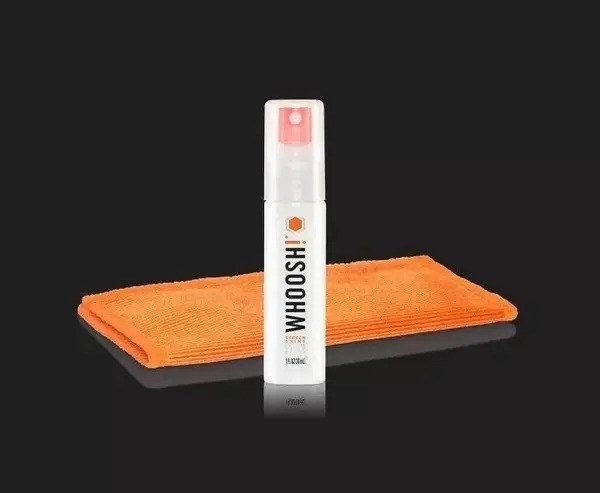 the cleaning solution with the orange cloth against a black background
