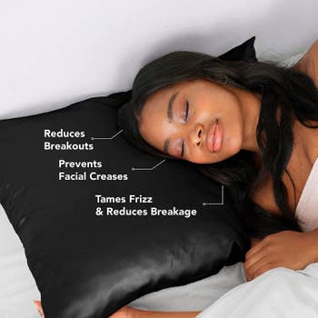 a model laying on the black pillow case with points that read: reduce breakouts, prevents facial creases, tames frizz and reduces breakage.