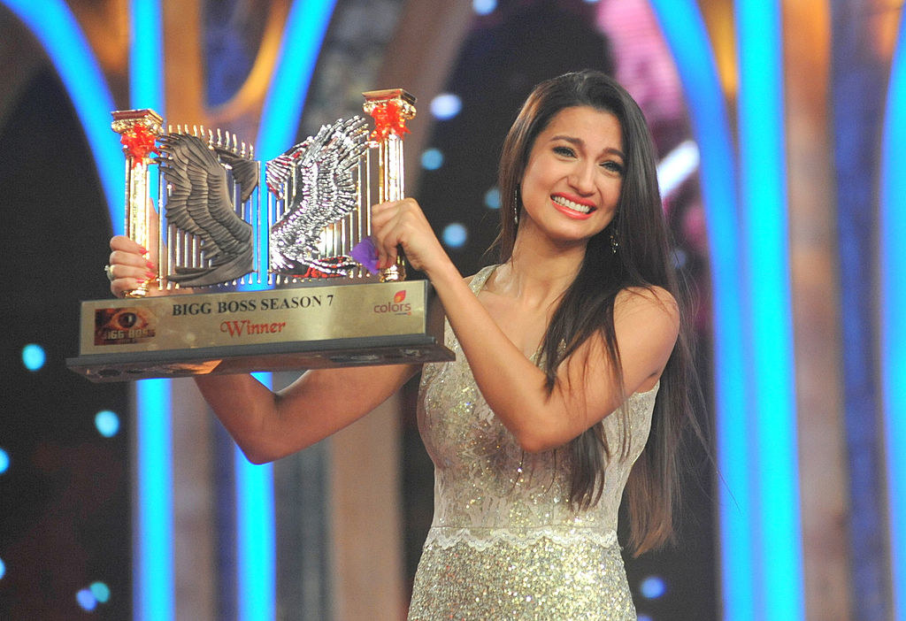 Indian model and actress Gauhar Khan poses with the Bigg Boss Season 7 reality television series trophy