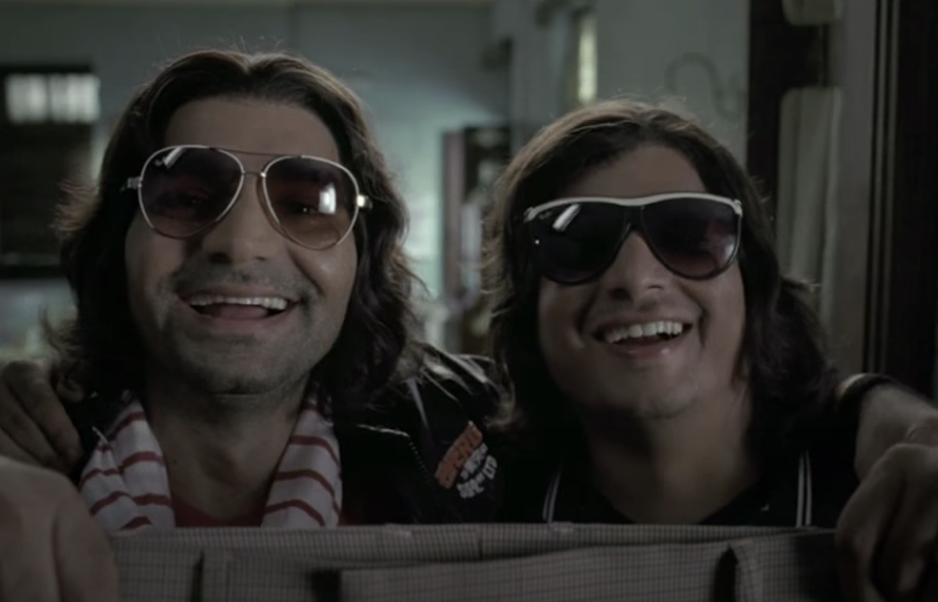 Two men wearing sunglasses smile