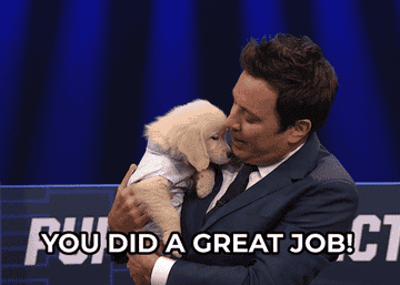 Jimmy Fallon holding a golden retriever puppy and telling him you did a great job
