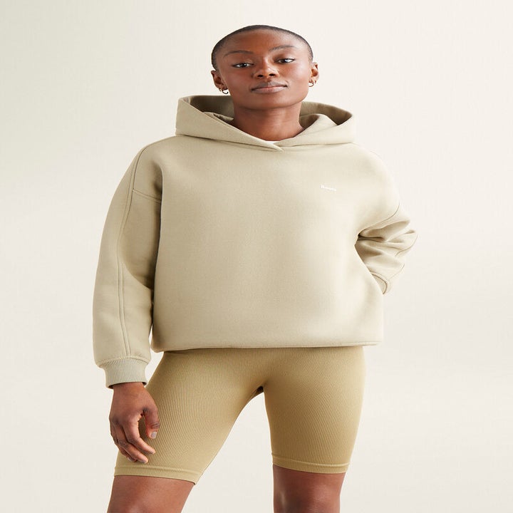 A person wearing the hoodie with bike shorts