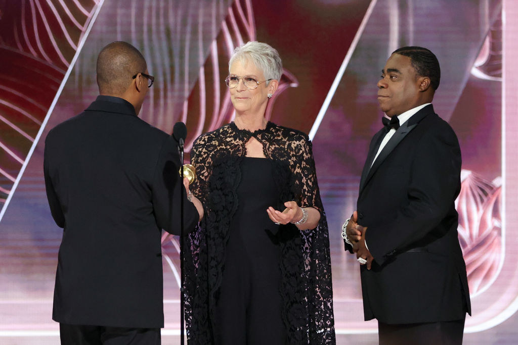 Honoree Eddie Murphy accepts the Cecil B. DeMille Award from Jamie Lee Curtis and Tracy Morgan onstage