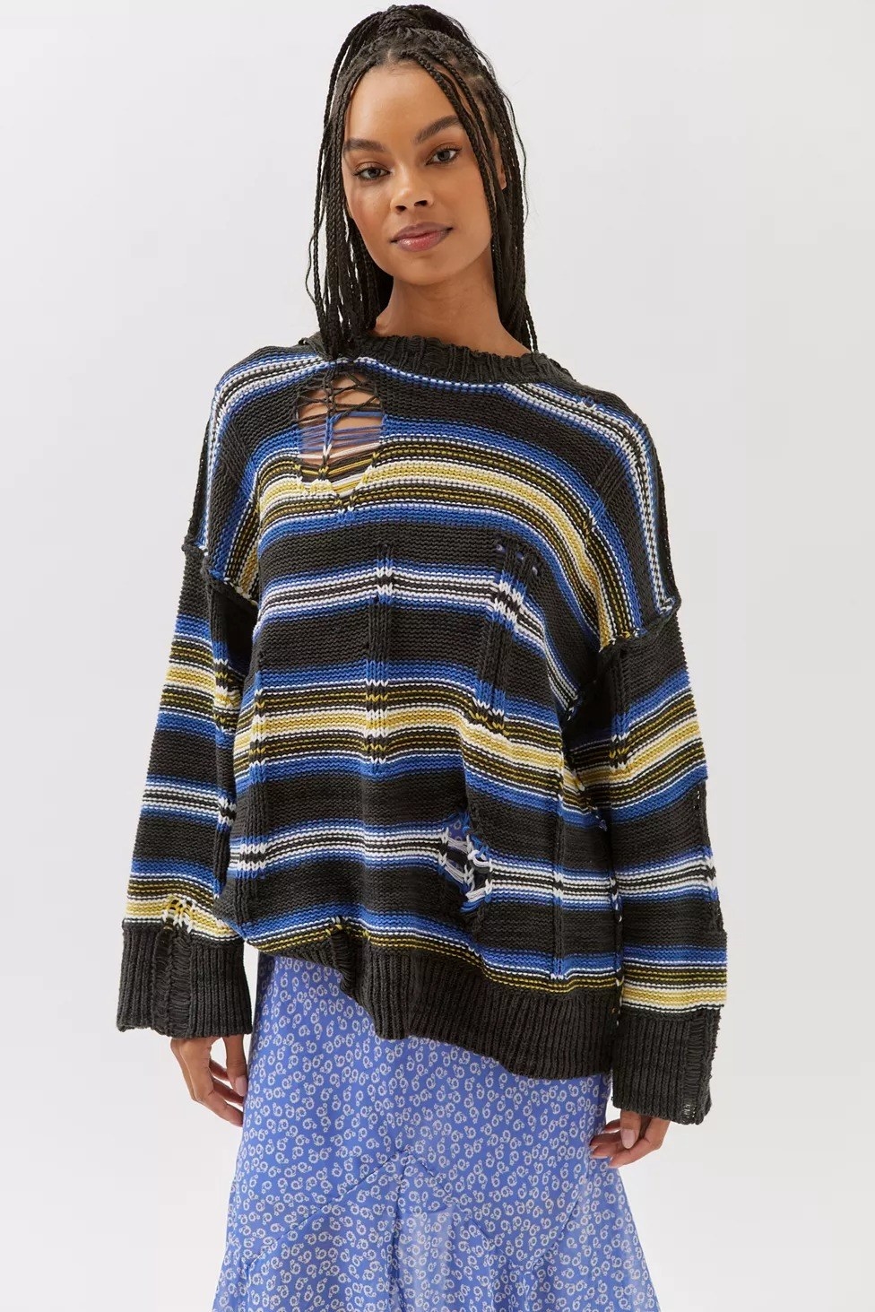 Model wearing the blue and yellow striped distressed sweater