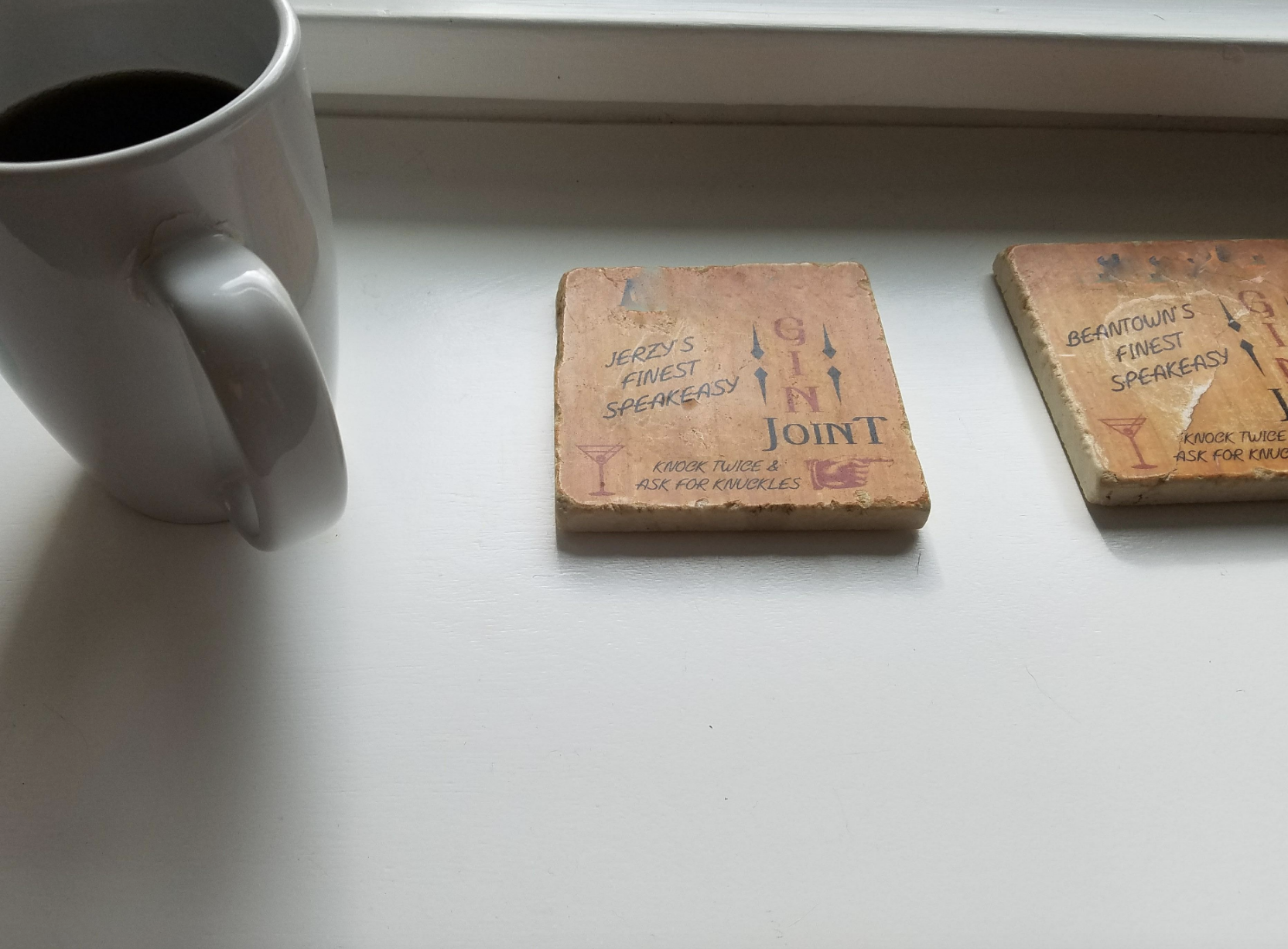 A cup next to coasters