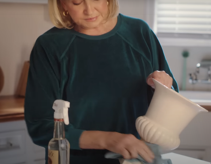 screenshot of ad: martha cleaning a vase with tito&#x27;s vodka