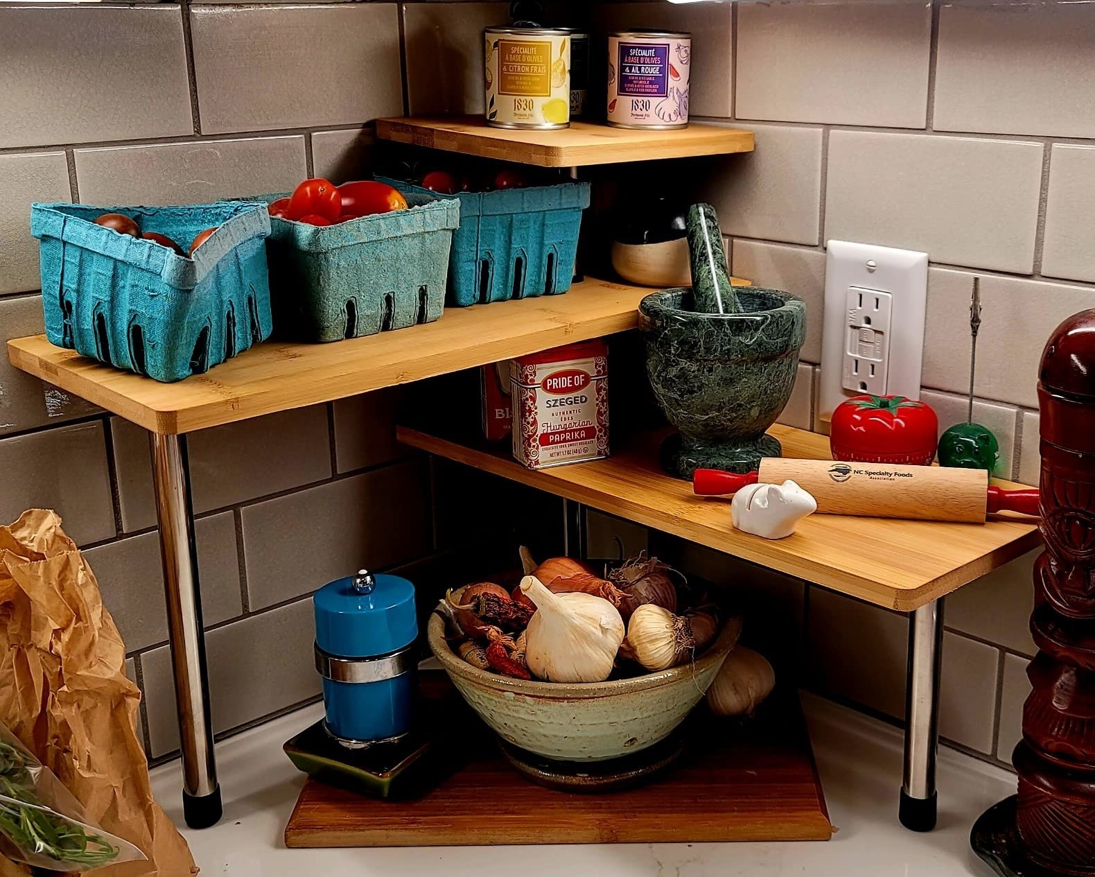 A reviewer home with the shelf and cooking supplies in various colors and sizes