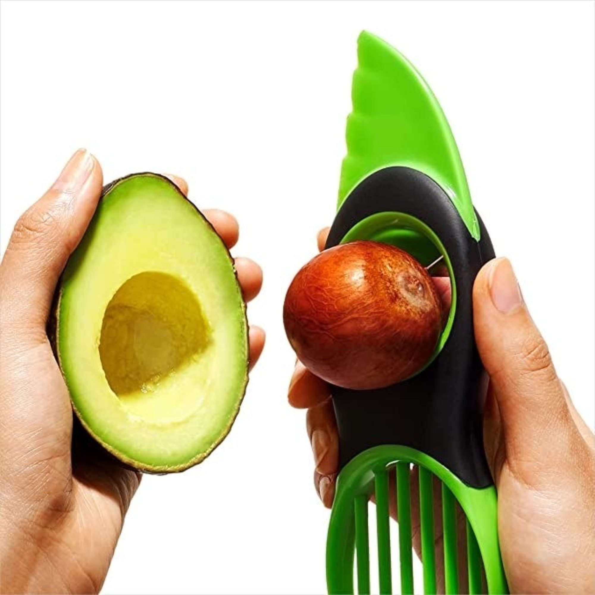 Hand using avocado tool to remove avocado pit