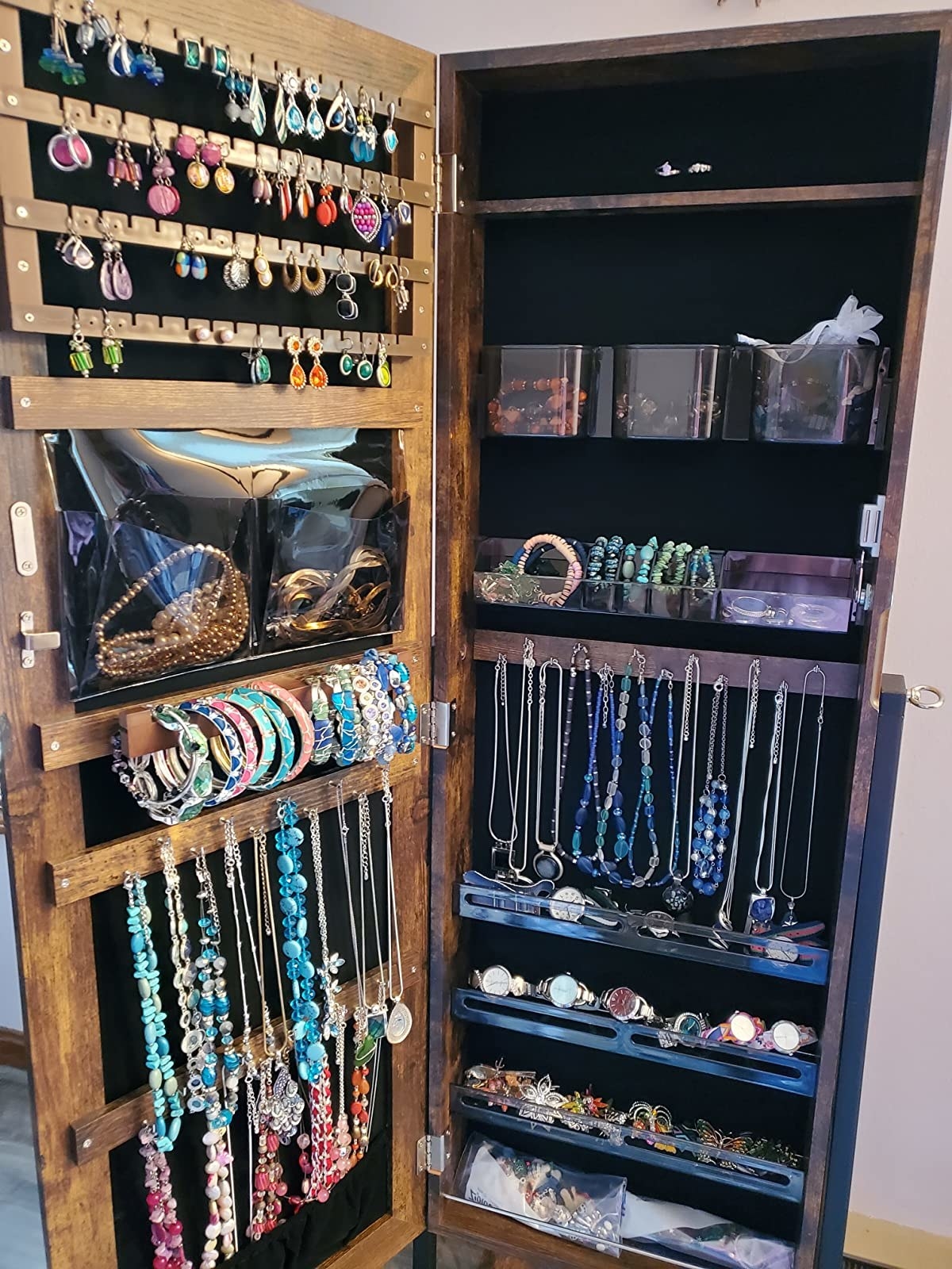 An interior picture of a reviewer&#x27;s jewelry collection inside a jewelry cabinet