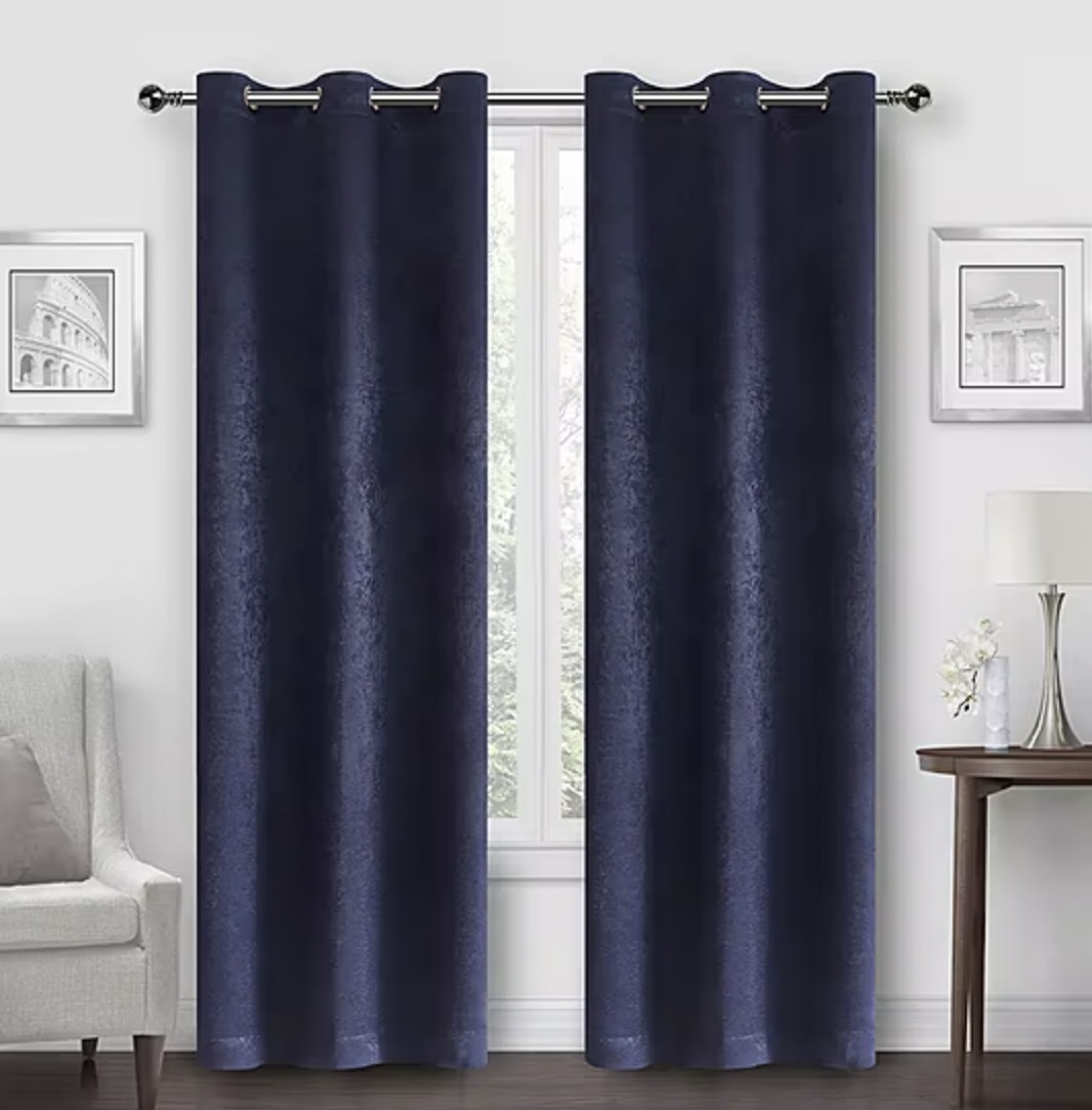 The blue curtains hanging on window