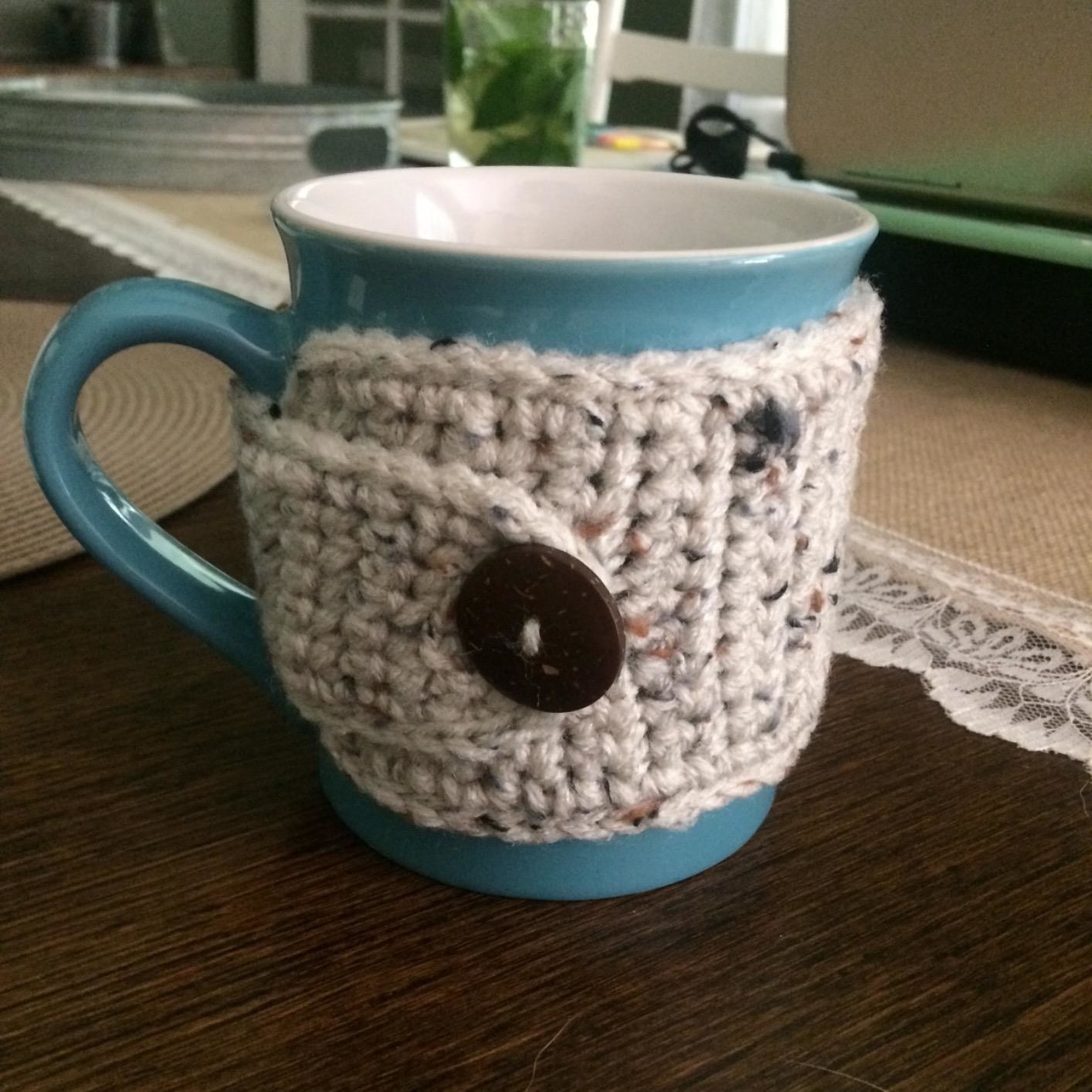 Reviewer&#x27;s mug in the cream colored crocheted mug sleeve