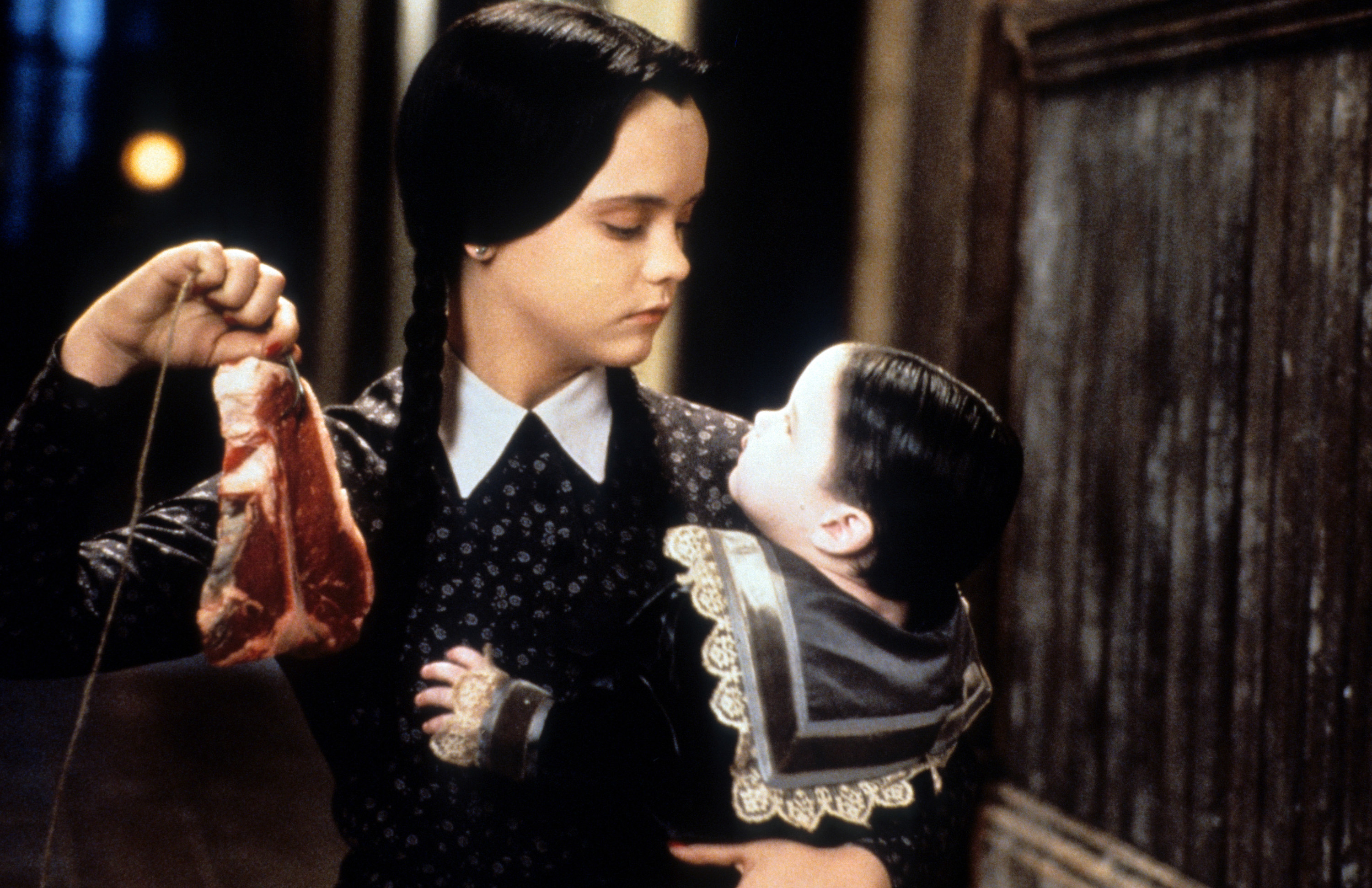 Christina Ricci dangling meat in a scene from the film &#x27;Addams Family Values&#x27;, 1993