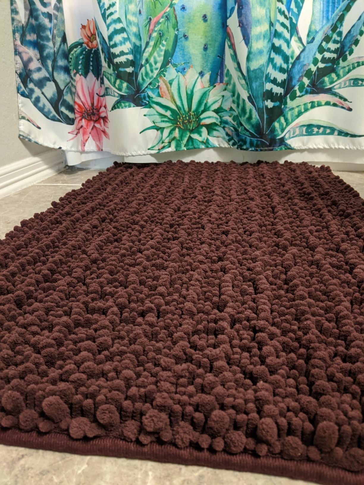 Reviewer&#x27;s close up of brown bathmat