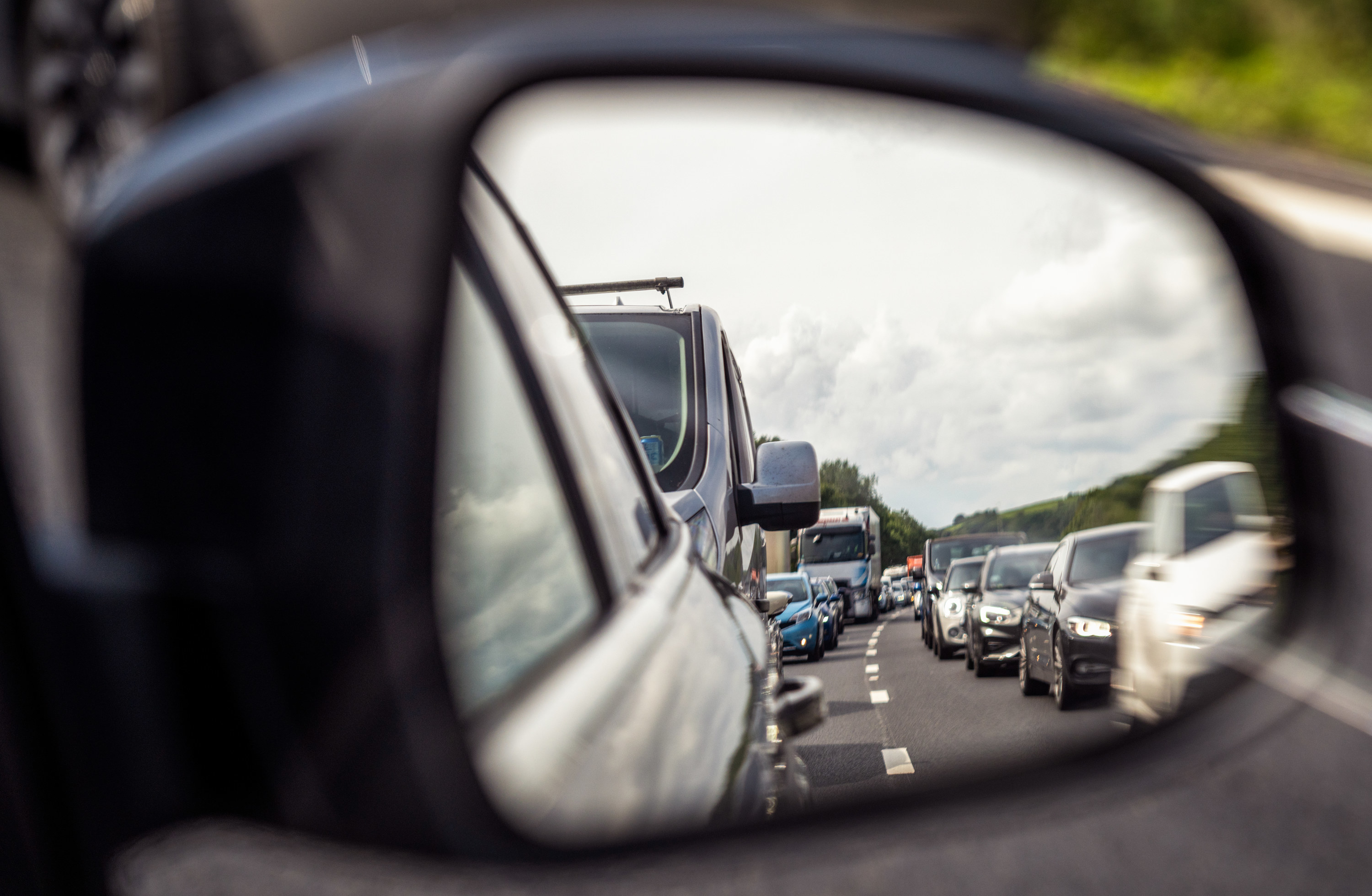 Car mirror with traffic jam in the reflection