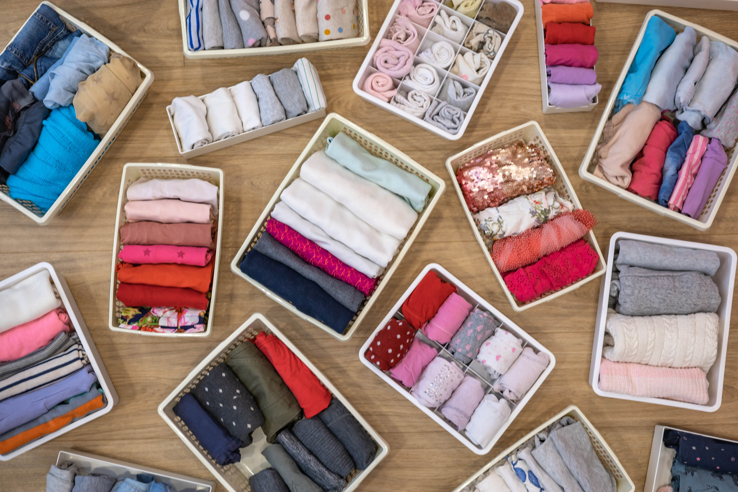 Neatly folded clothes in organization bins