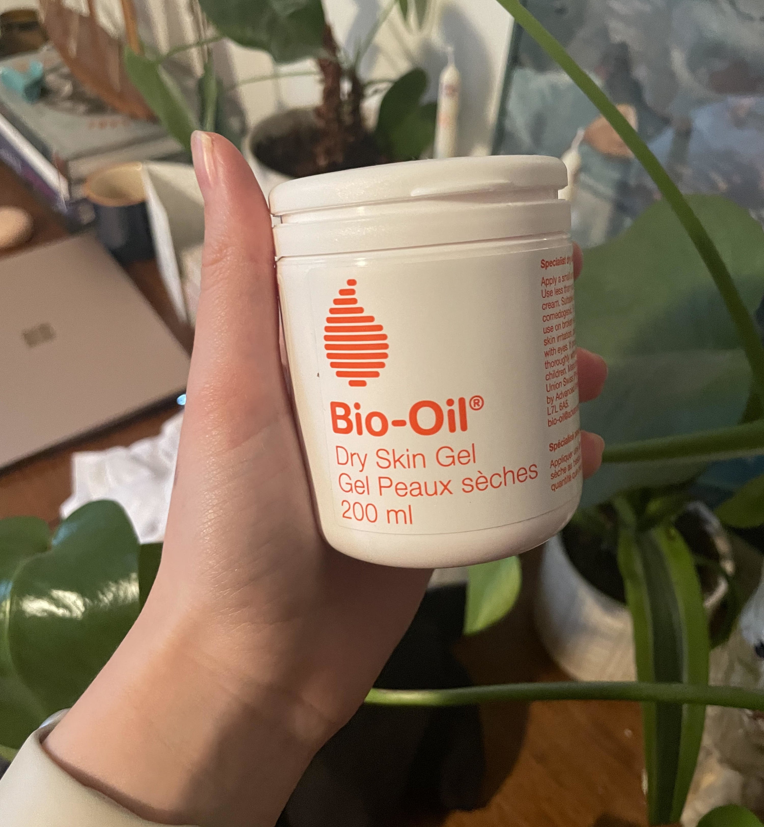 alice holding up a tub of bio oil dry skin gel