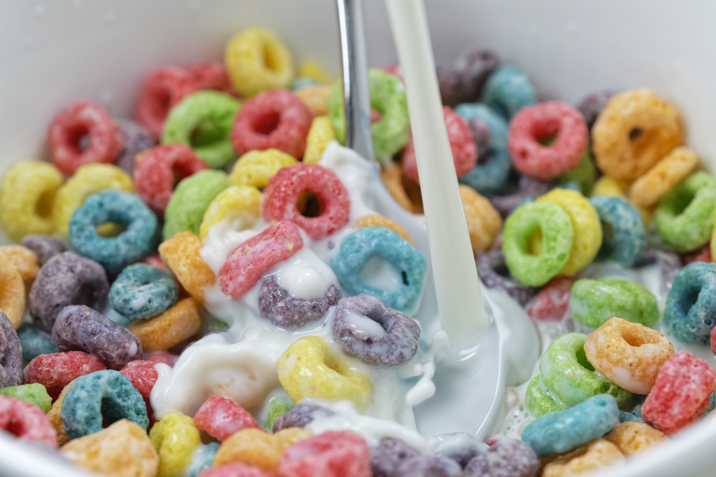 cereal in a bowl with milk being poured