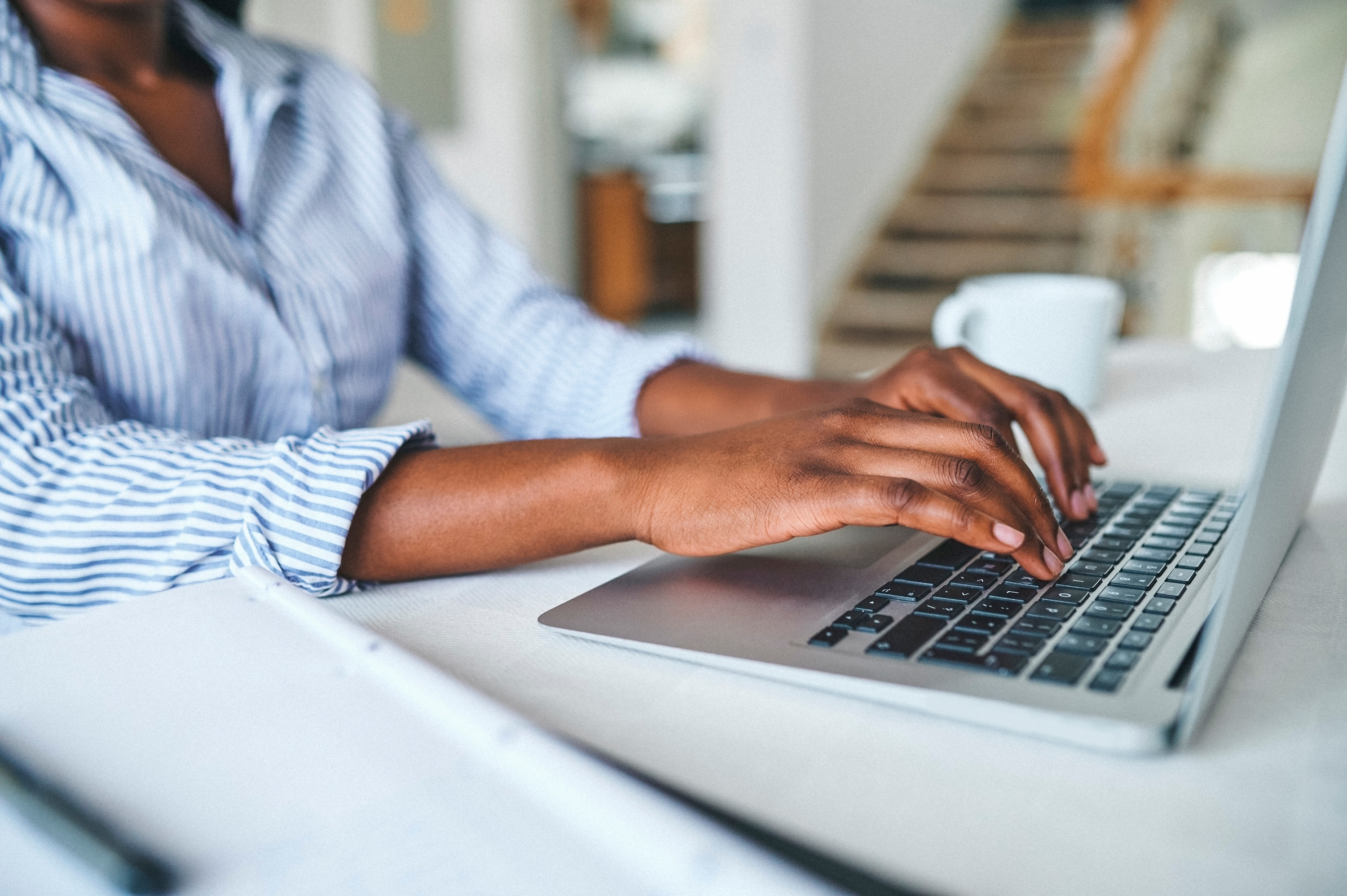 Someone typing on a laptop