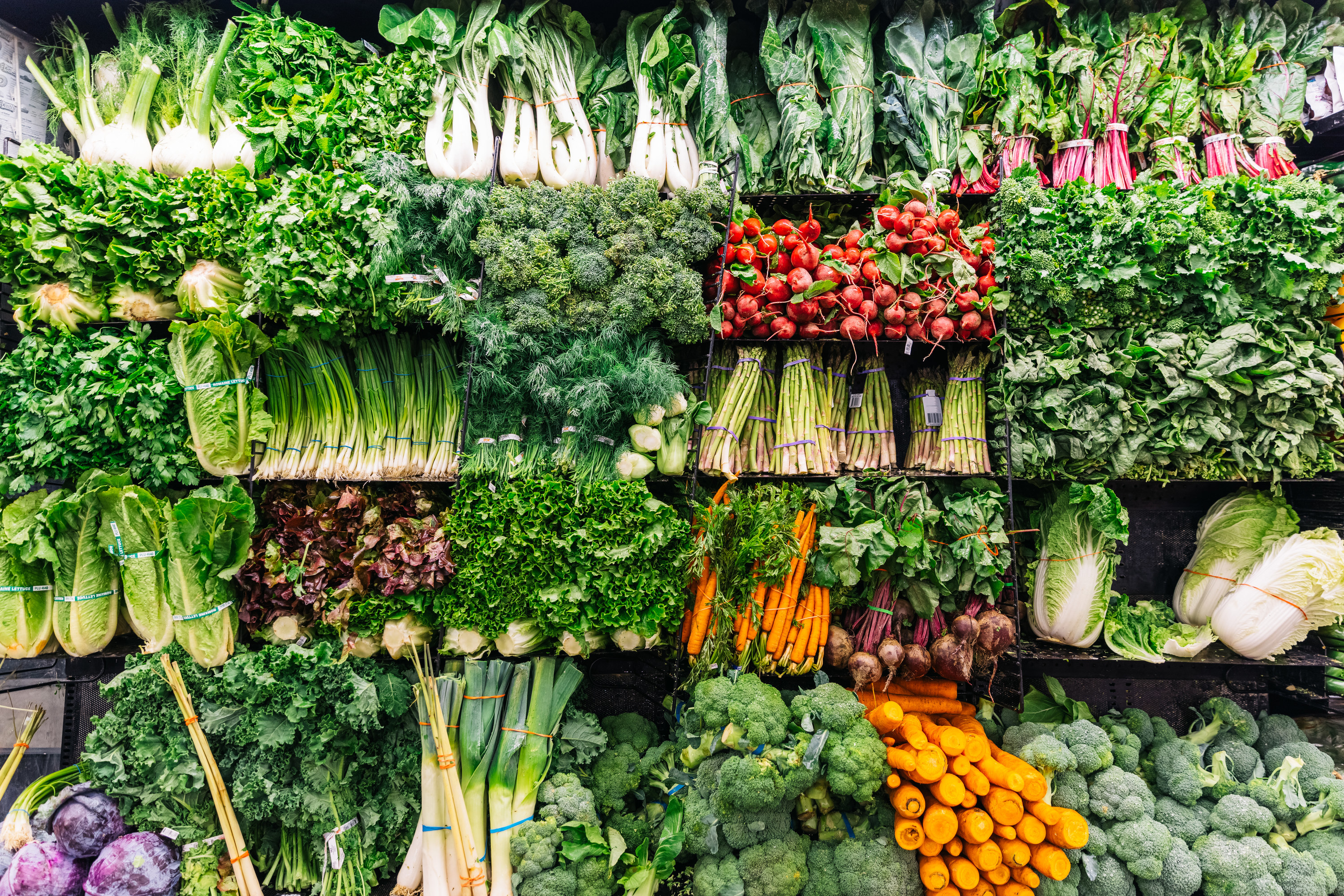 vegetables on shelves in a store