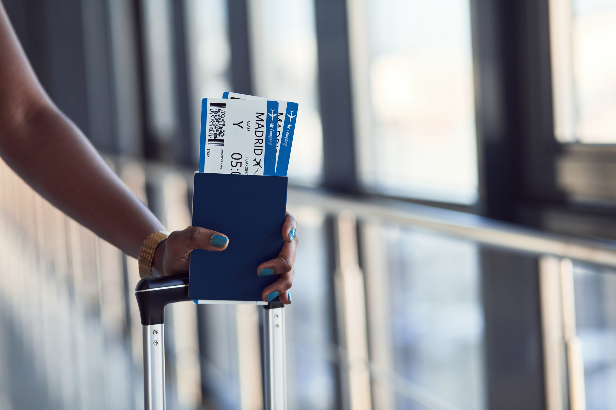 A person holding plane tickets