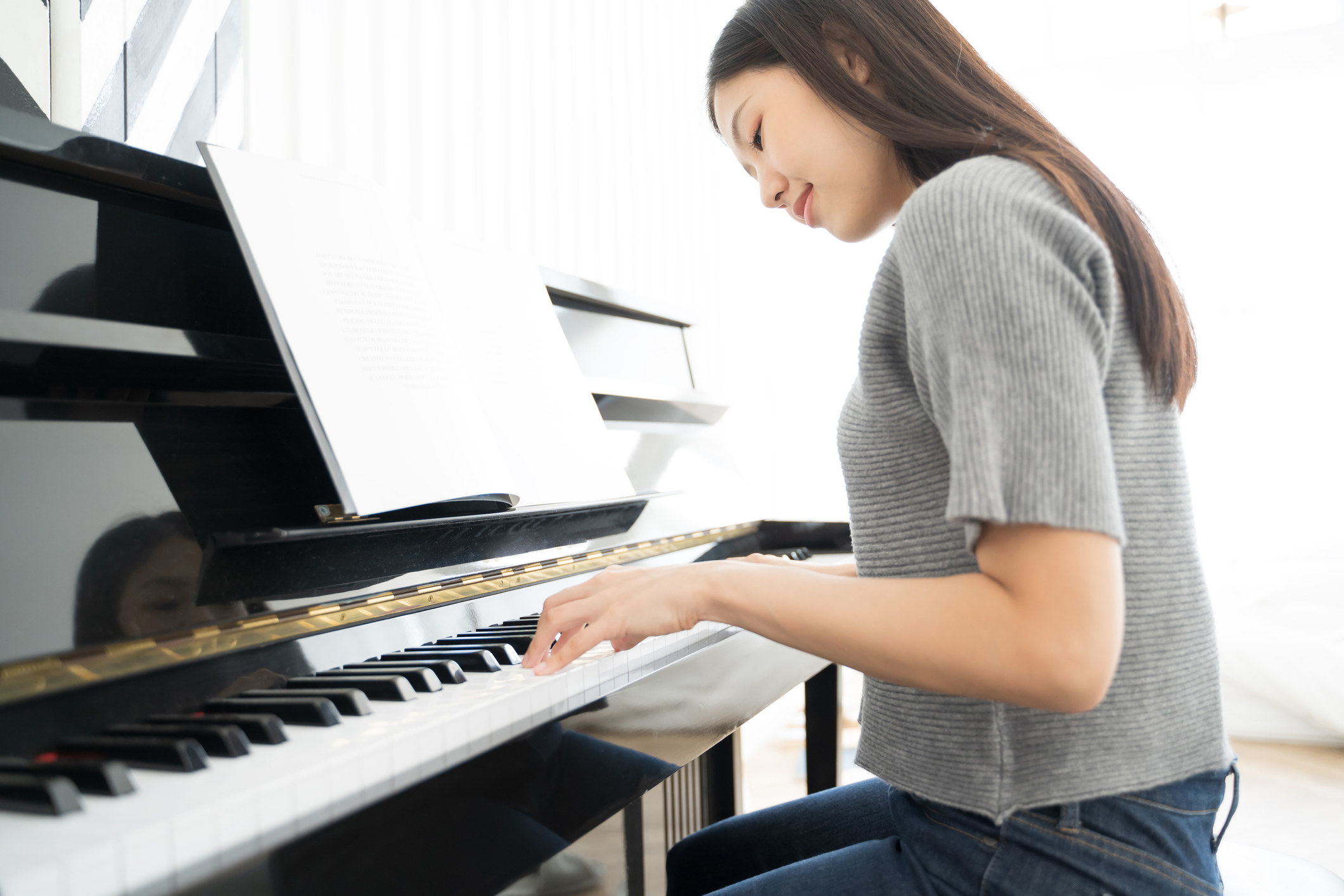 A young woman playing piano