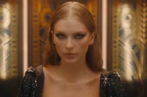 Taylor Swift looking up as she exits an elevator in the Bejeweled music video