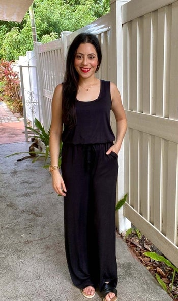 reviewer wearing black jumpsuit