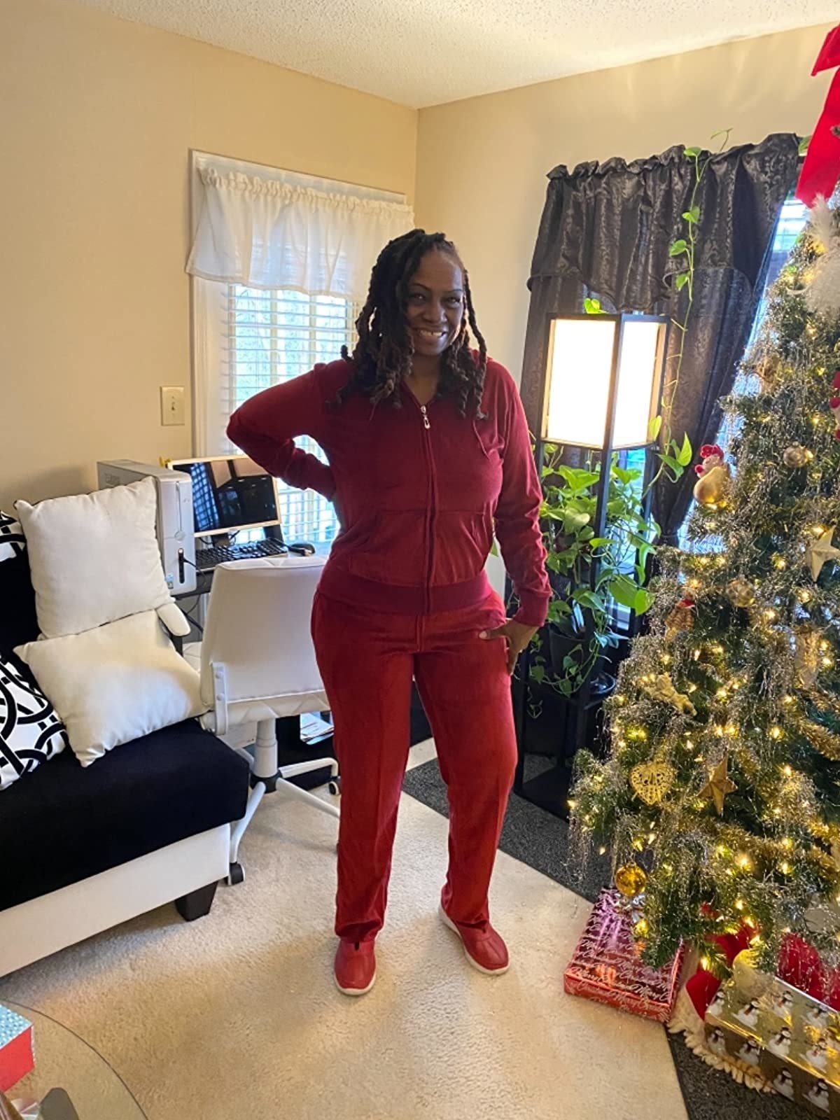 Reviewer wearing velour tracksuit in red