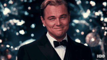 Leonardi DiCaprio raises his glass to cheer