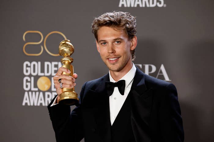 Austin holding his Golden Globe and smiling