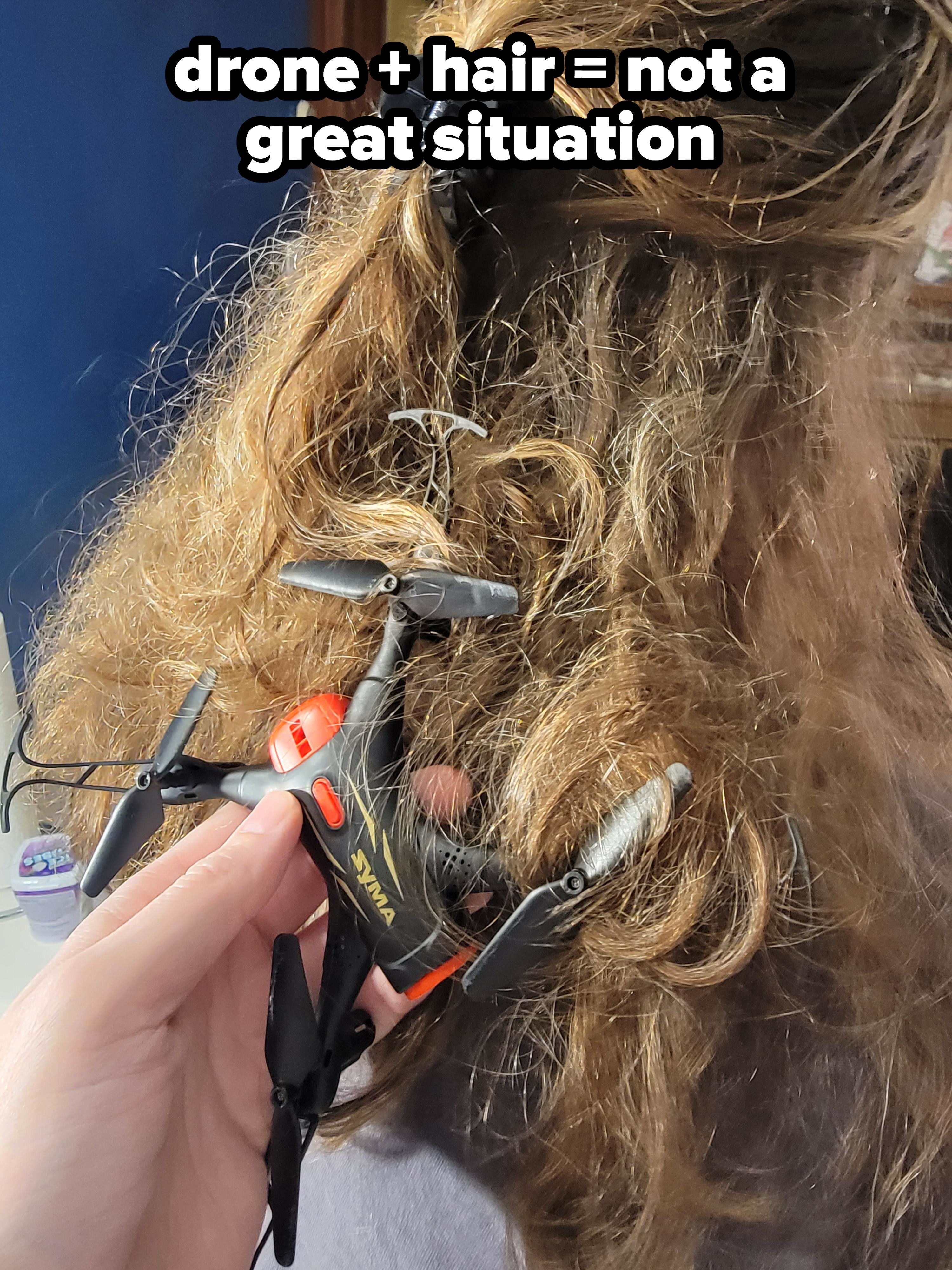 A small drone tangled up in long hair