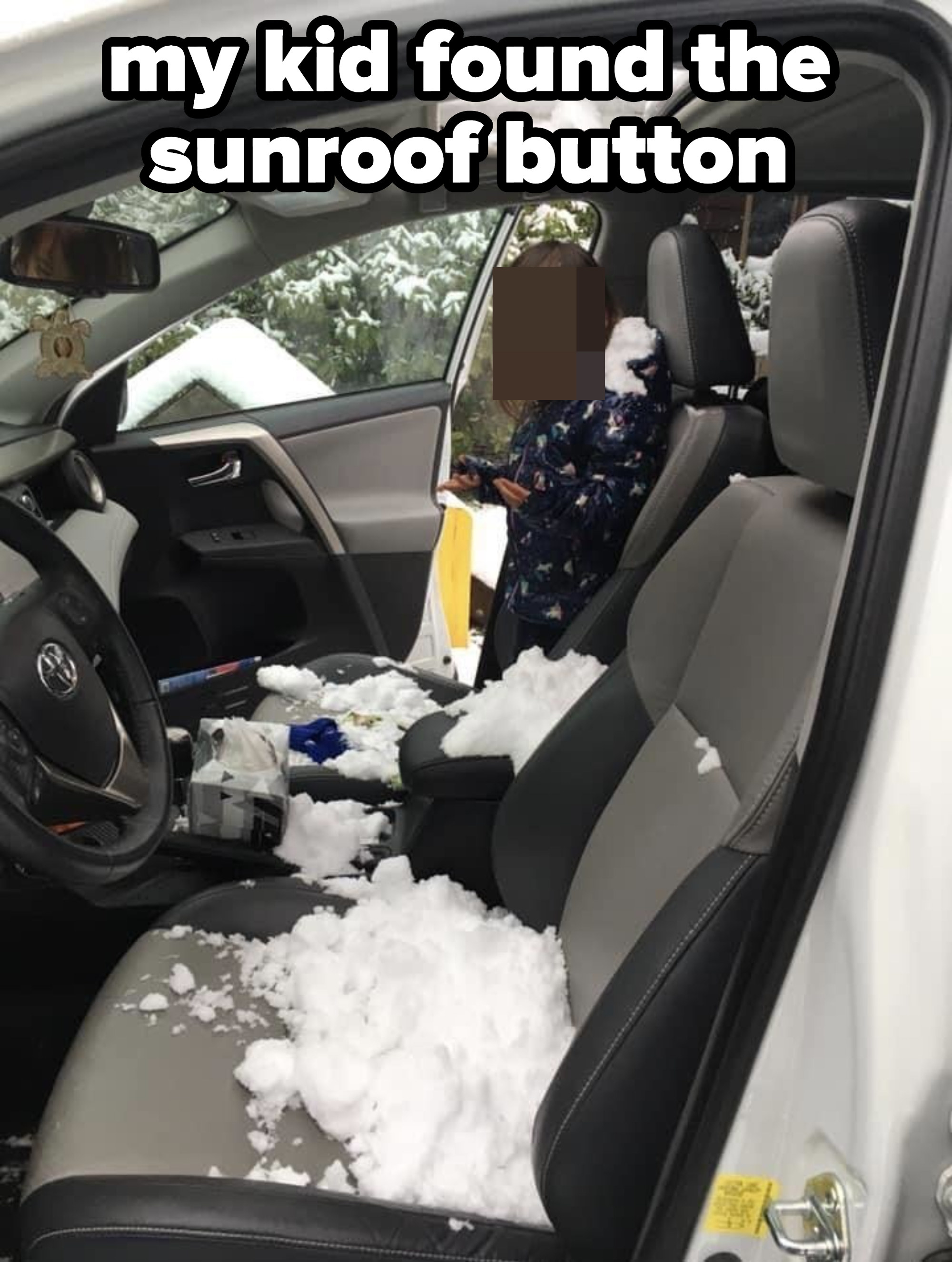 Snow in the front seat of a car with an open sunroof