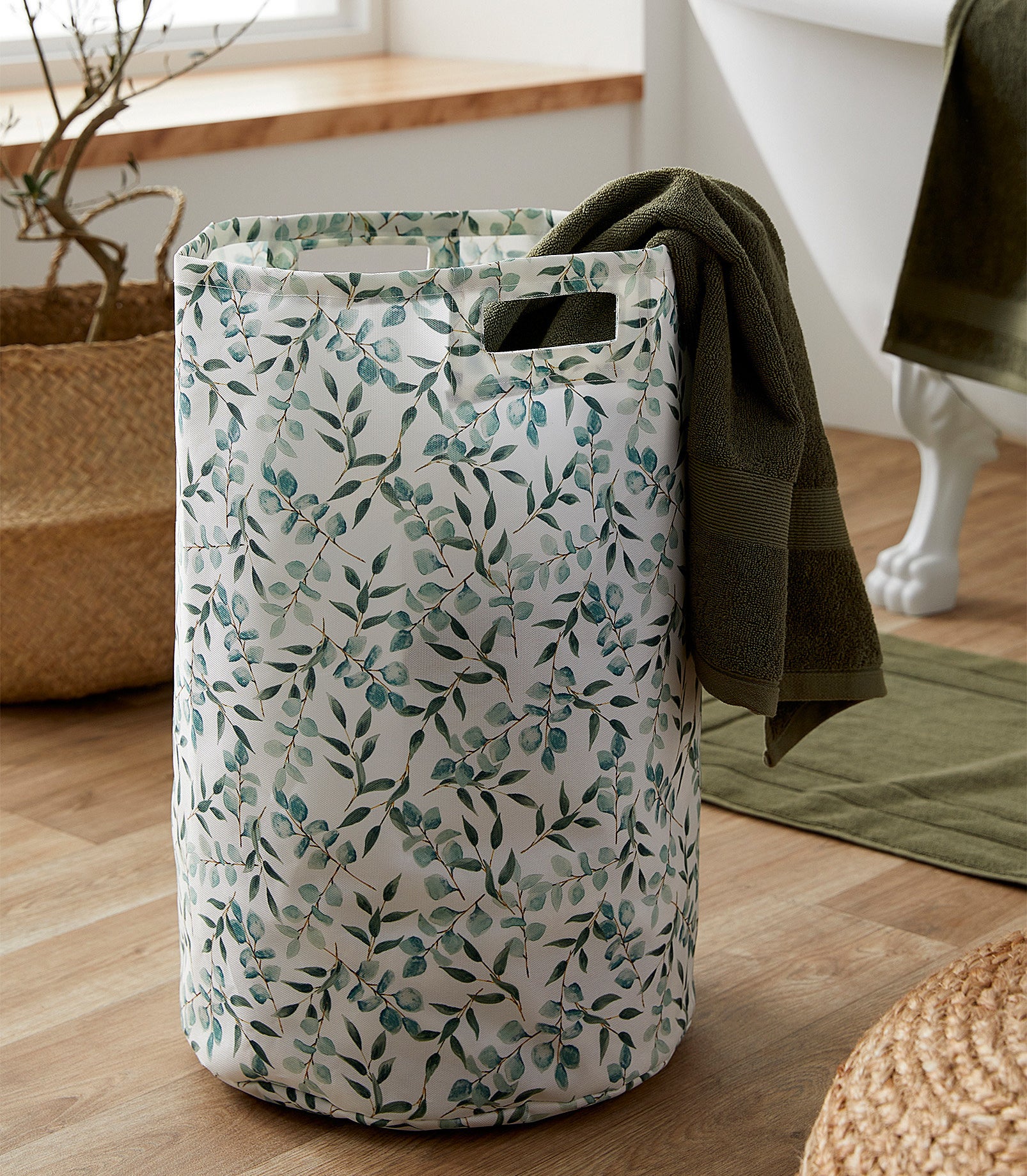 a laundry hamper with a eucalyptus pattern