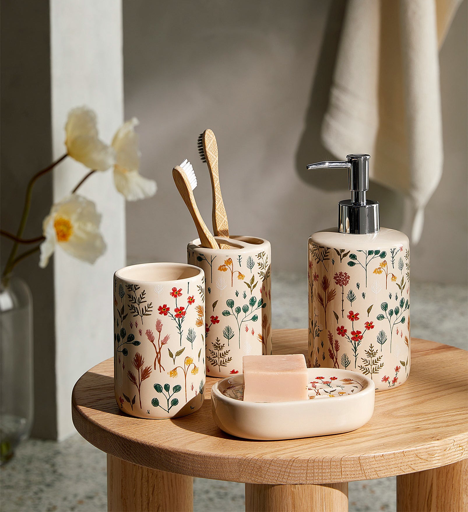a set of bathroom accessories with floral patterns on each
