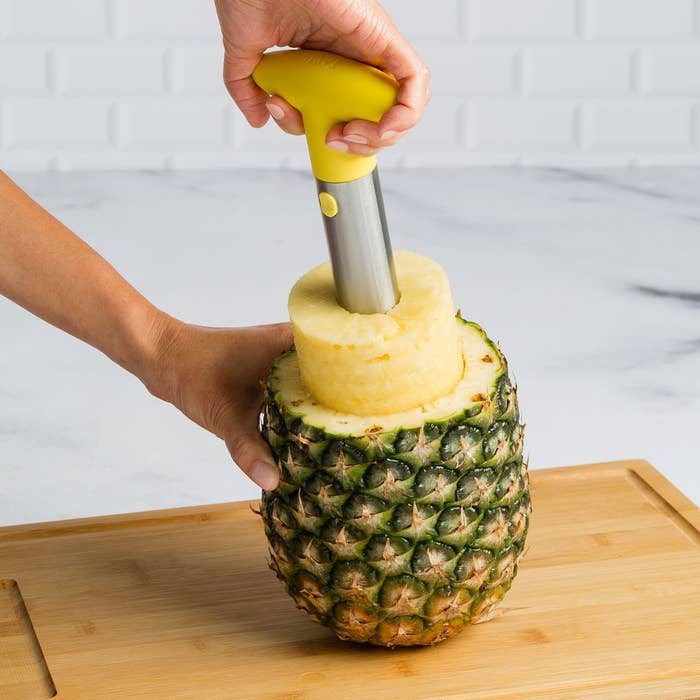 model coring a pineapple with the tool