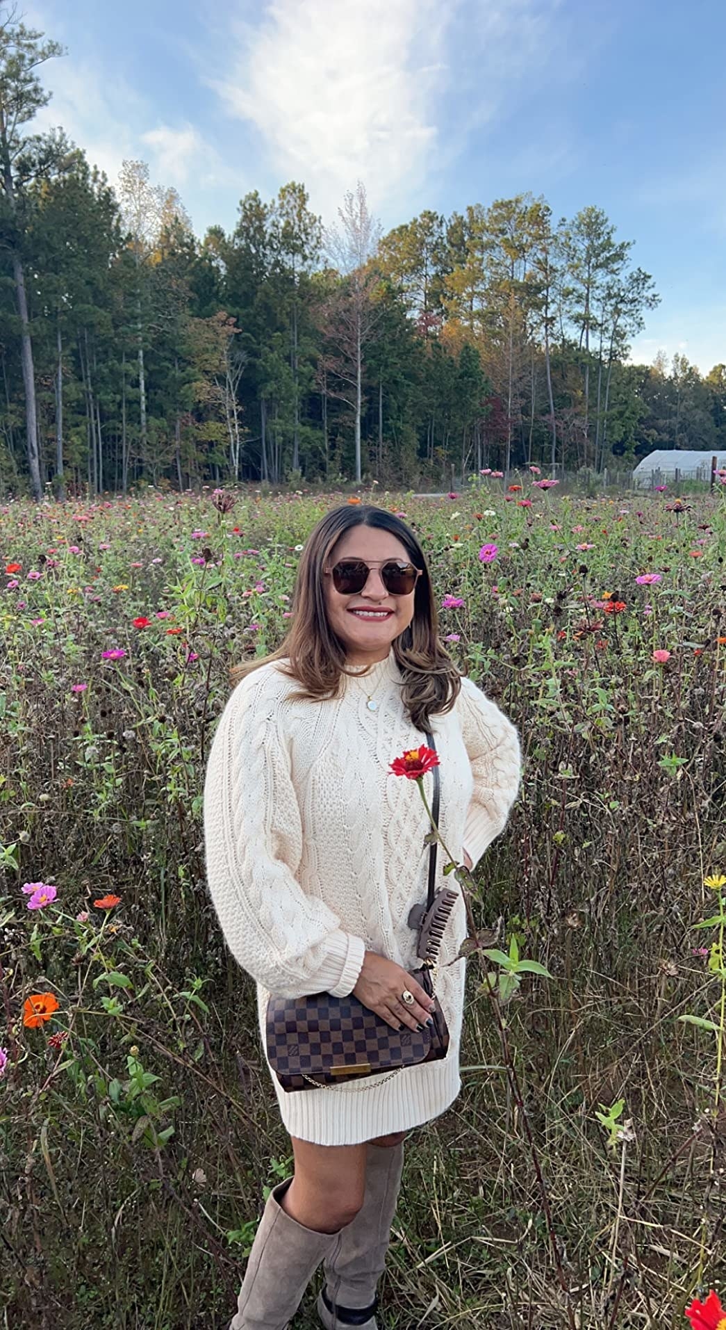 Reviewer standing in the field in white dress