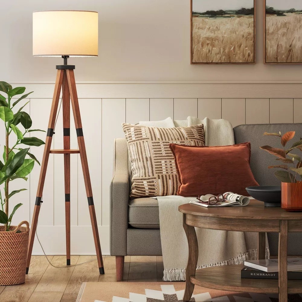 the wooden tripod lamp in a living room
