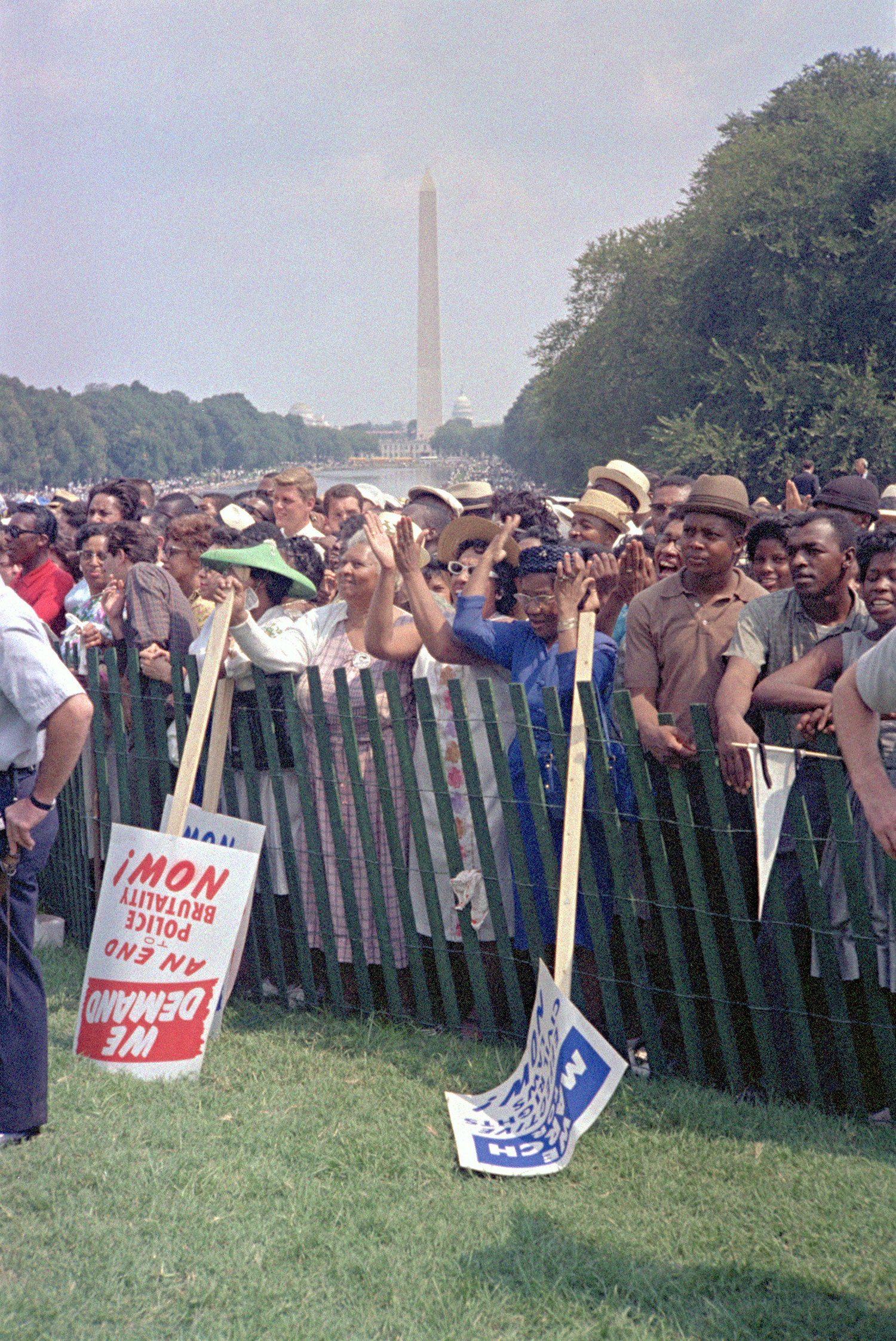 Attendees of the March on Washington are seen behind a fence.