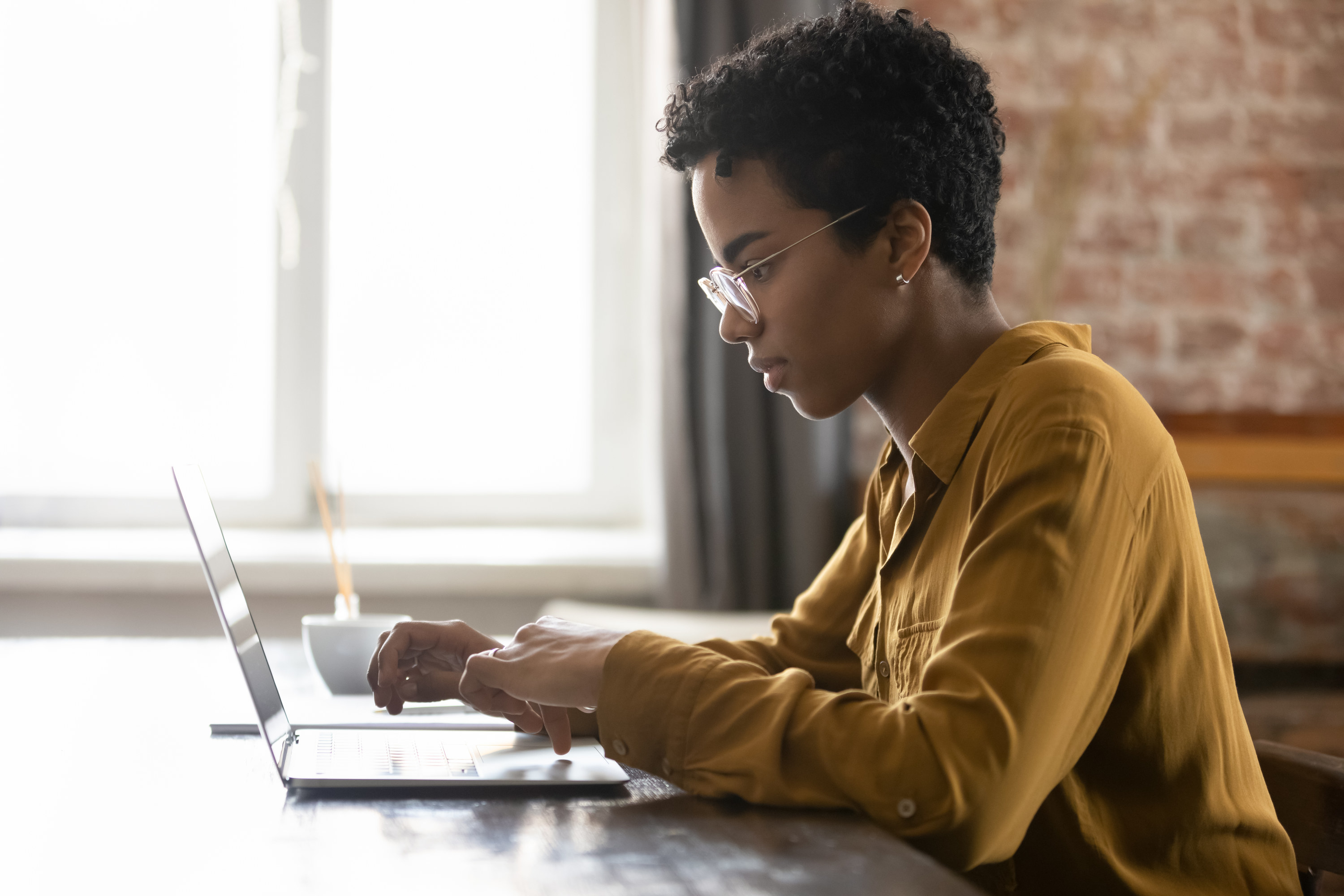 Woman going over her finances on a laptop