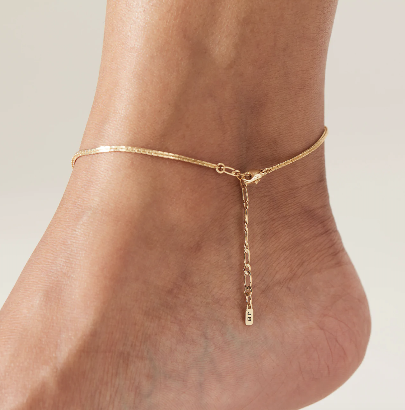 person with the anklet around their foot