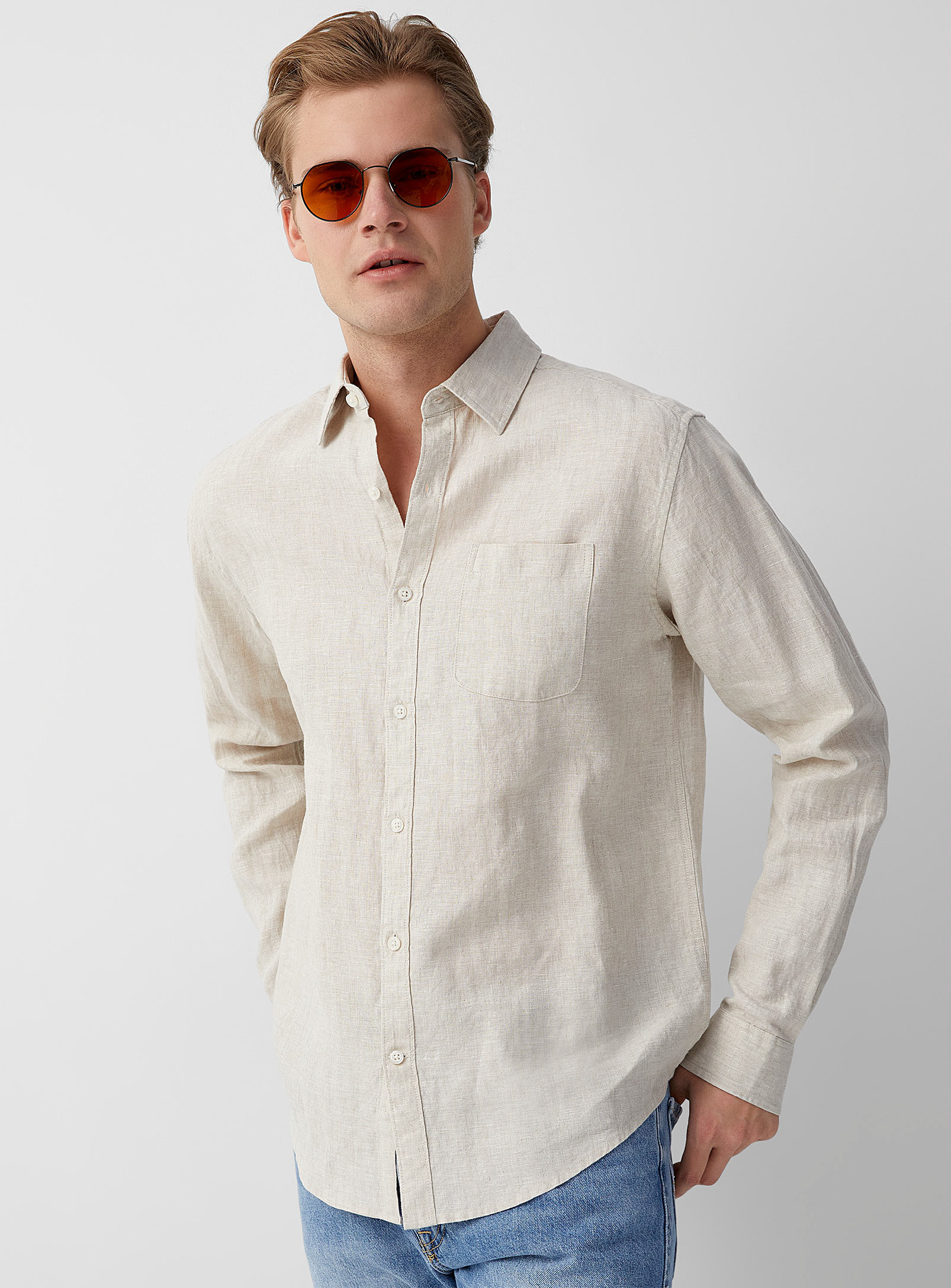 person wearing the linen shirt with jeans and sunglasses
