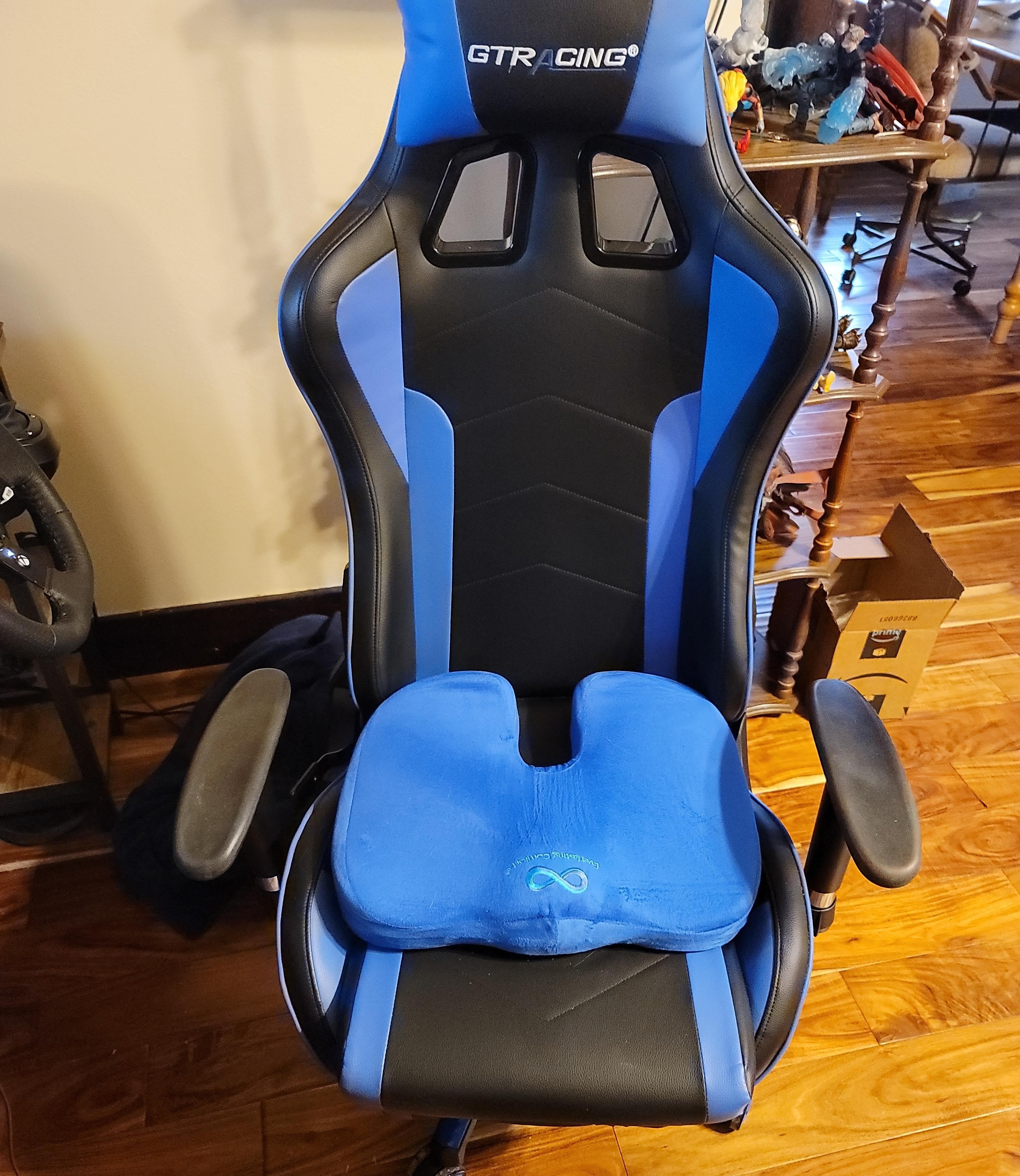 The seat cushion on a black and blue gaming chair