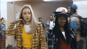 Iggy in a music video flipping her hair