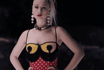 Iggy twirling her hair in a music video