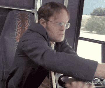 dwight driving a giant work bus on he office