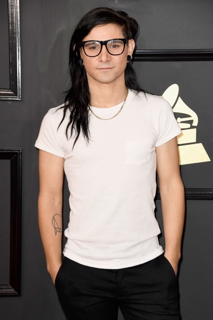 Closeup of skrillex with long hair and glasses