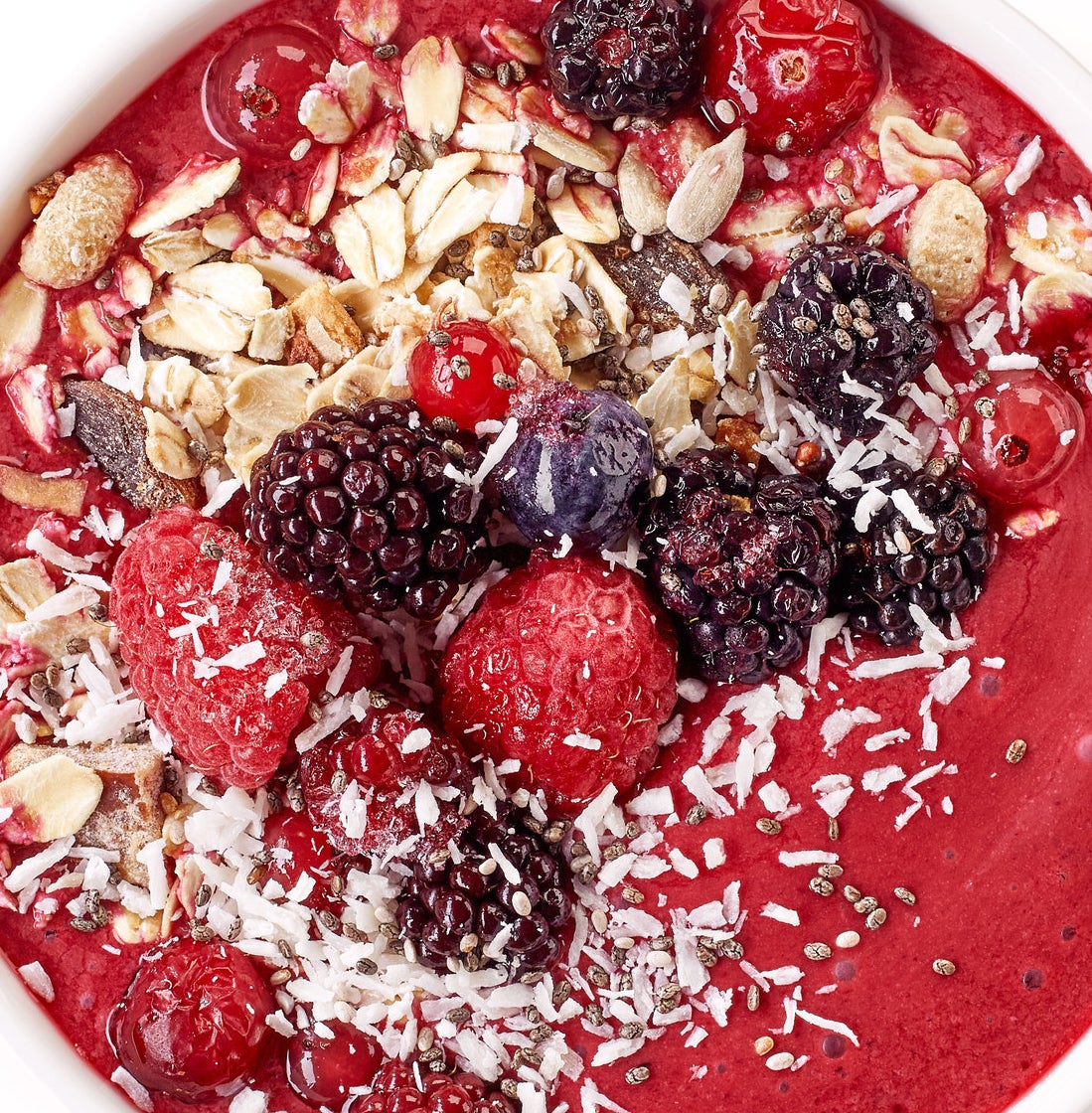 A smoothie bowl with berries and coconut flakes
