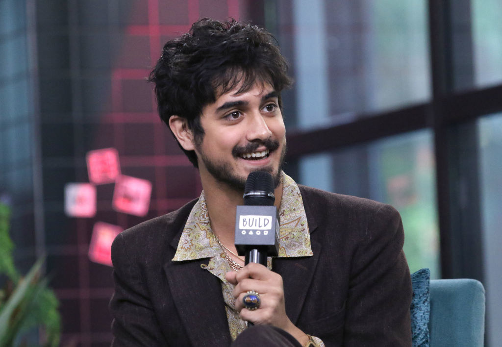 Avan Jogia holding a mic