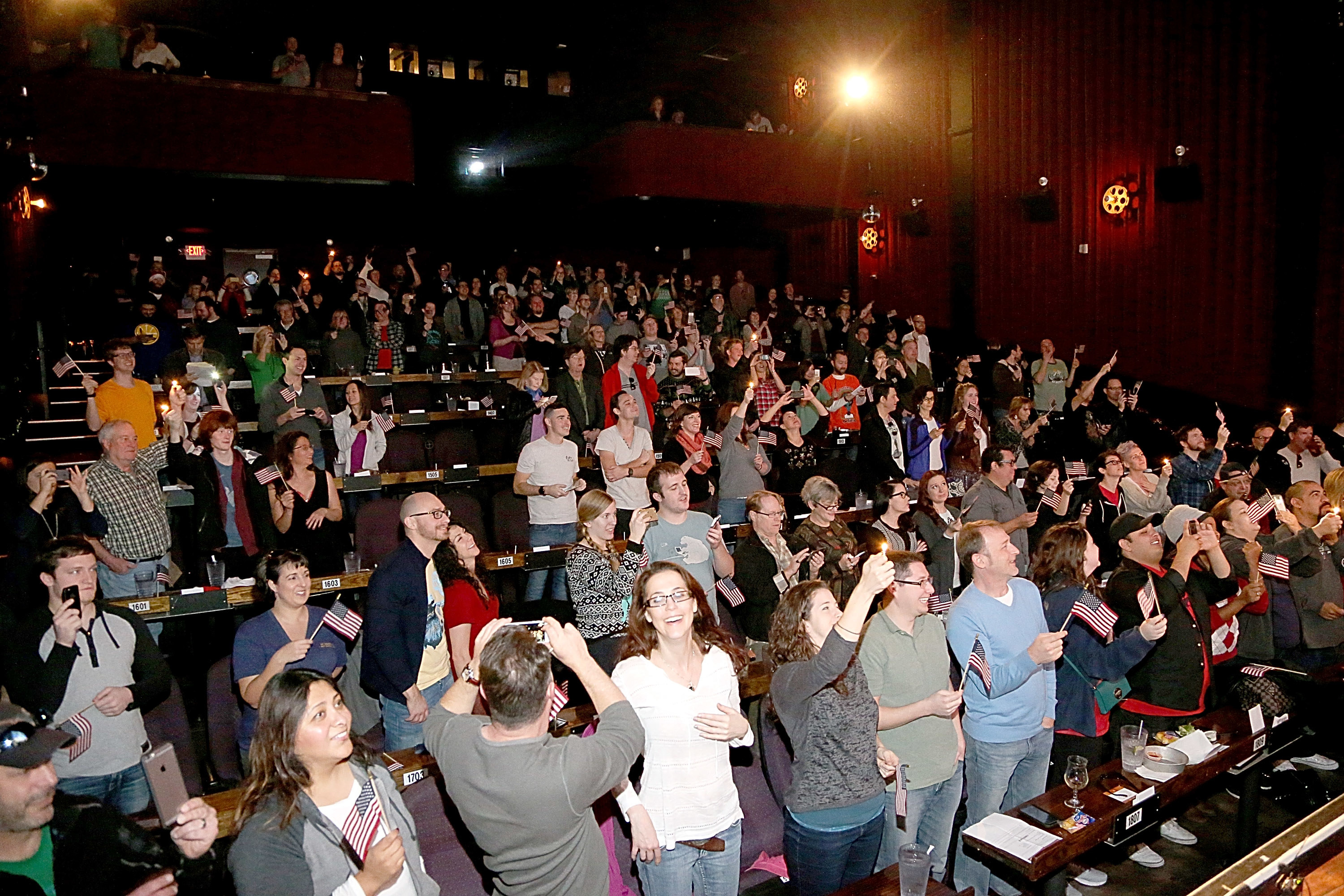Movie goers sing along to &quot;Proud To Be An American&quot; before a screening of Sony Pictures&#x27; &quot;The Interview&quot; at the Alamo Drafthouse in Austin, TX