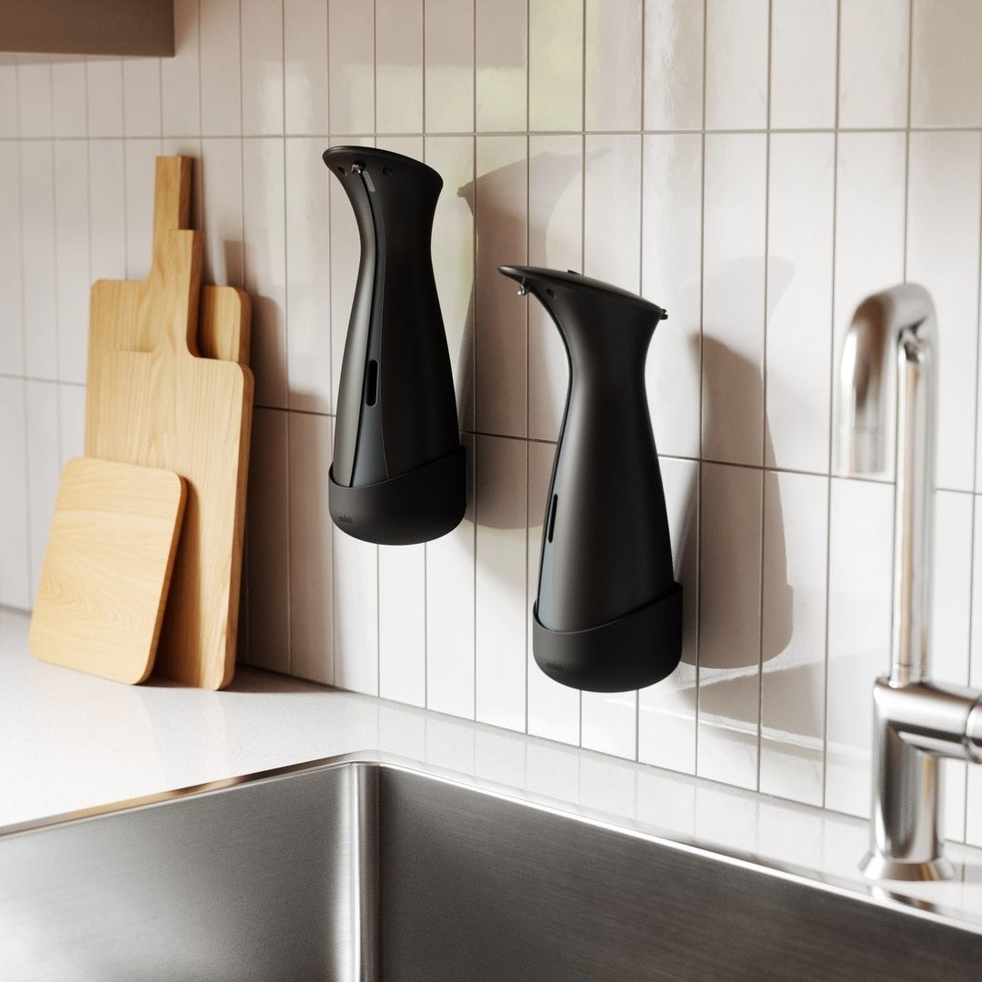 a pair of wall-mounted soap dispensers in a kitchen